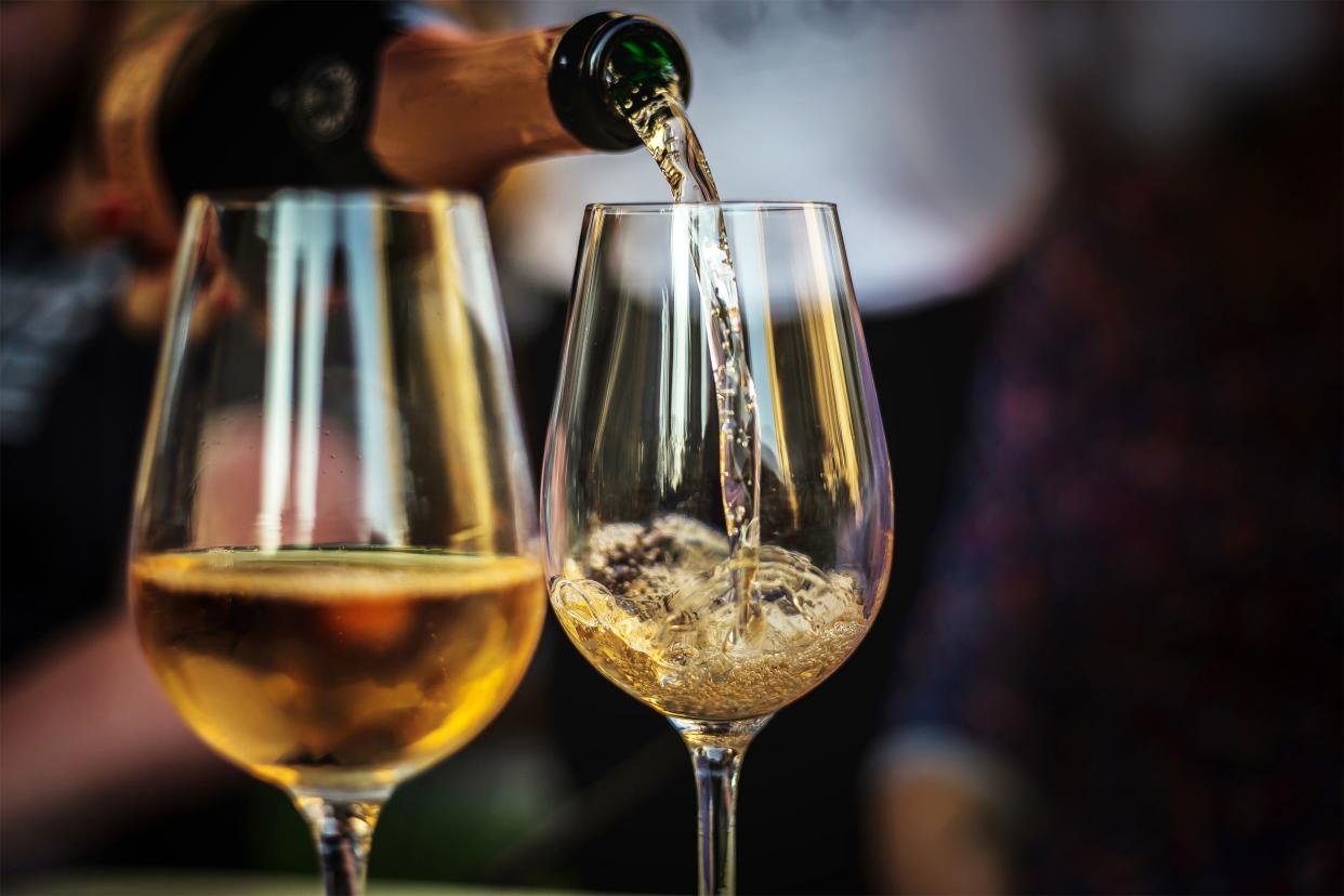 Closeup of wine pouring into glasses