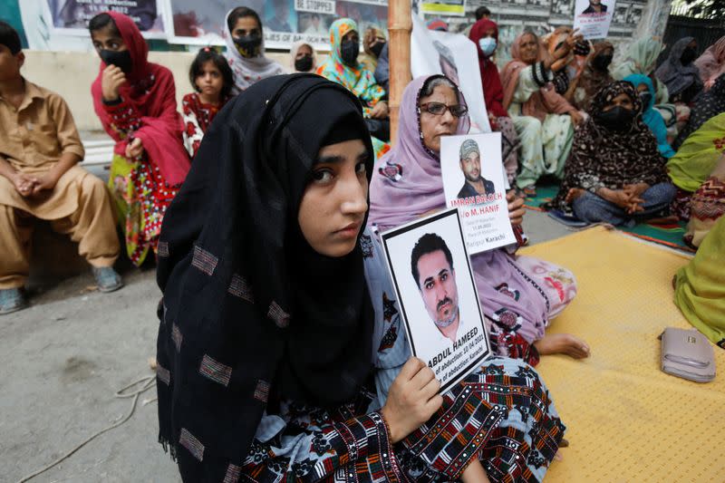 Family members of missing or disappeared persons of the Baloch people hold portraits of their loved ones during a protest in Karachi