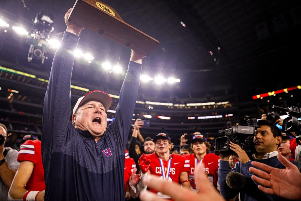 Westlake coach Todd Dodge lifts the Class 6A Division II state championship trophy after the Chaps' defeated Denton Guyer 40-21 at AT&T Stadium in Arlington in December. Dodge, who retired after the season, received the coach of the year award from the Texas Sports Writers Association after leading Westlake to a 16-0 record while extending the Chaps’ winning streak to 40 games, which is the third-longest active streak by a public high school in the nation.