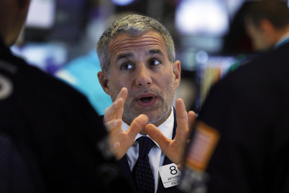 Specialist Anthony Rinaldi talks with colleagues on the floor of the New York Stock Exchange, Tuesday, June 11, 2019. Stocks are rising early Tuesday as Wall Street continues to thrive in June. (AP Photo/Richard Drew)