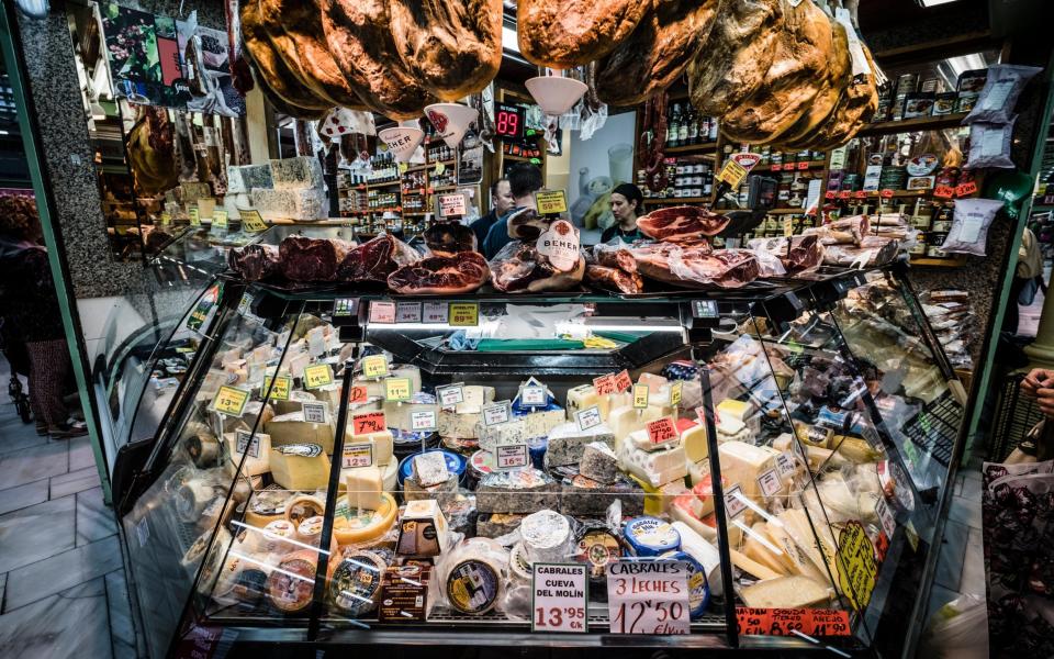 A large selection of different cheeses on the counter at the Fontan food market in Oviedo, the Spanish gastronomic capital for 2024