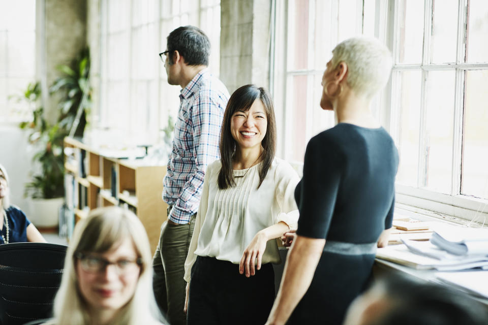 Female coworkers in discussion. Source: Getty