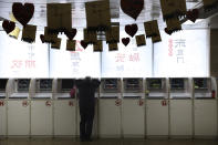 A Chinese man monitors stock prices at a brokerage in Beijing, Friday, Oct. 19, 2018. Asian stock markets sank Friday after Wall Street declined on losses for tech and industrial stocks and Chinese economic growth slowed.(AP Photo/Ng Han Guan)