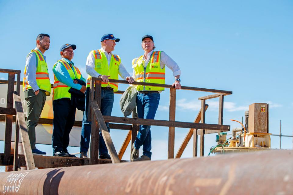 California Governor Gavin Newsom, right, listens to Controlled Thermal Resources CEO Rod Colwell talk about the lithium extraction taking place on the site in Calipatria, Calif., on Monday, March 20, 2023. At left, Congressman Raul Ruiz and Torres Martinez Desert Cahuilla Indians Chairman Thomas Tortez, Jr. listen. 