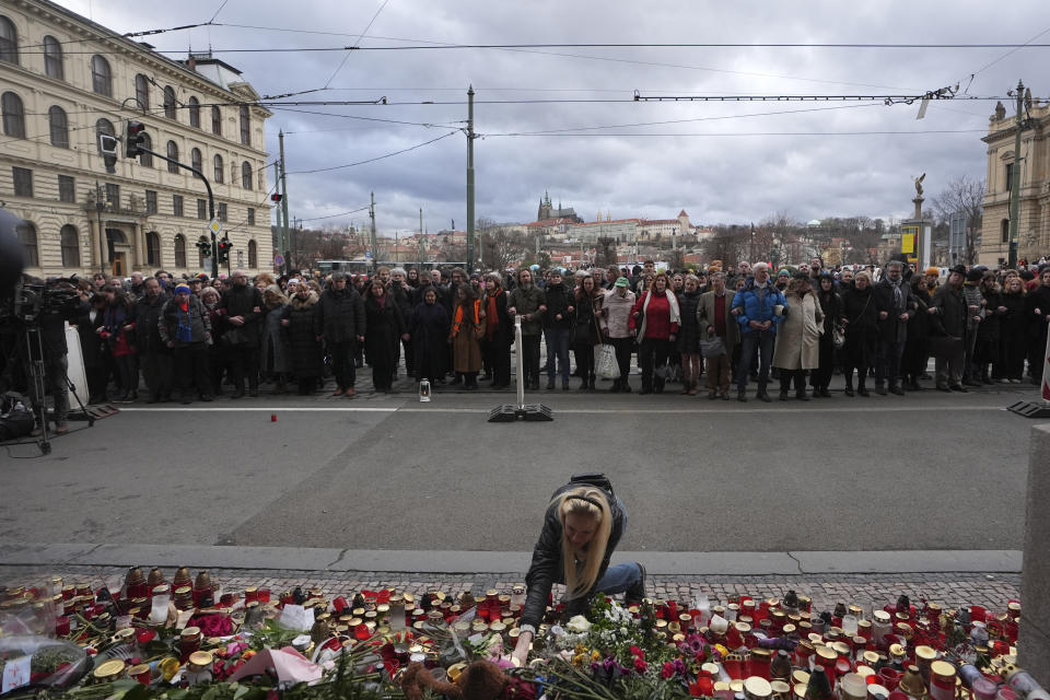 People stand as a human chain to honor victims of mass shooting in front of the building of Philosophical Faculty of Charles University in Prague, Czech Republic, Thursday, Jan. 4, 2024. Thousands of students and other Czechs marched in silence in the Czech capital on Thursday to honor the victims of the country's worst mass killing that left 14 dead on Dec. 21, 2023. (AP Photo/Petr David Josek)