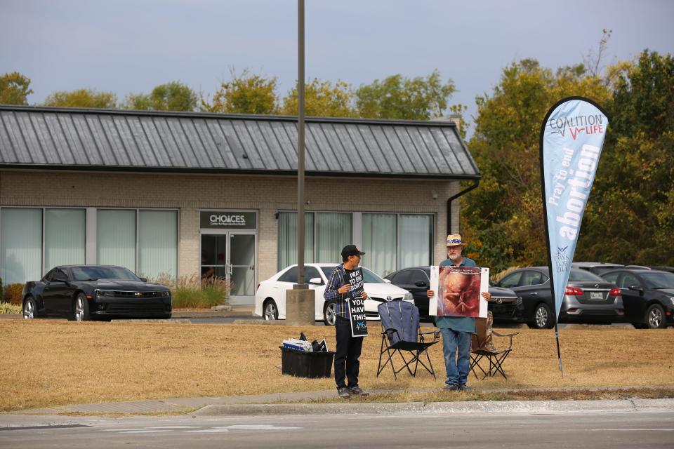 Anti-abortion protesters stand outside the first of a least two new abortion clinics opening in Carbondale, Illinois, on Tuesday, Oct. 11, 2022.