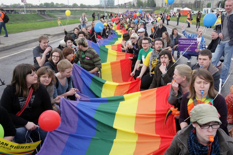 People take part in the ''Baltic Pride 2010'' march, Lithuania's first gay pride event, on May 8, 2010, in Vilnius. Lithuania's gay community on Monday denounced restrictions placed on television publicity for this month's gay pride parade, saying they were akin to Russia's so-called "gay propaganda" ban