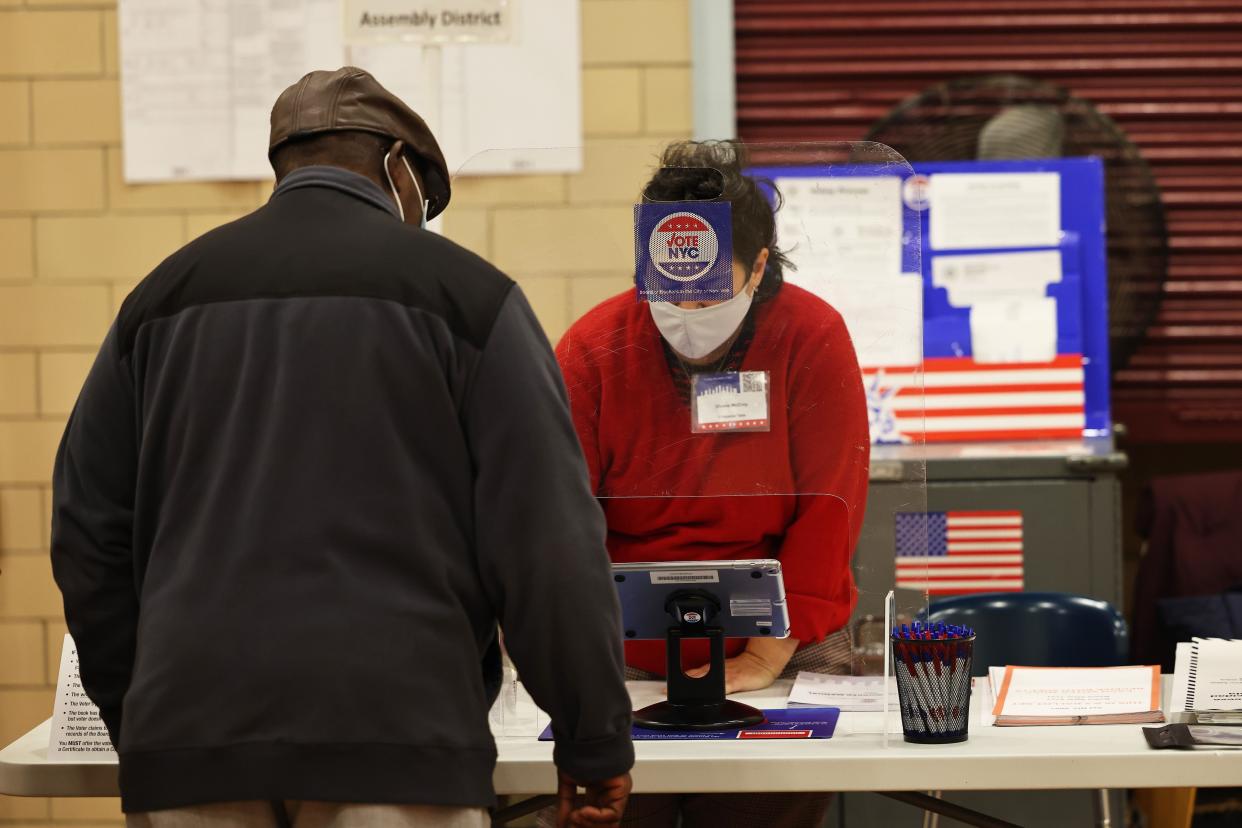 A man checks in as he prepares to vote on Election Day at P.S. 11 Purvis J. Behan Elementary on Nov. 02, 2021, in the Clinton Hill neighborhood of Brooklyn.