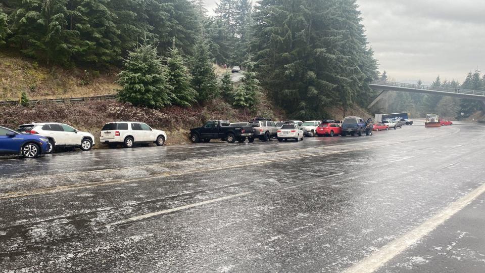 Over 30 cars, a city snowplow and the Willamette Pass ski bus are piled up near the Spring Boulevard overpass on East 30th Avenue in Eugene Friday morning after an ice storm passed through the area overnight.