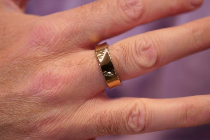 A person wearing the gold Samsung Galaxy Ring.