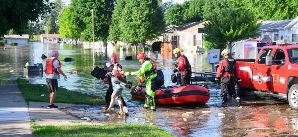 Officials perform a water rescue in Sioux City, Iowa on Monday as floodwaters put thousands in danger (AP)