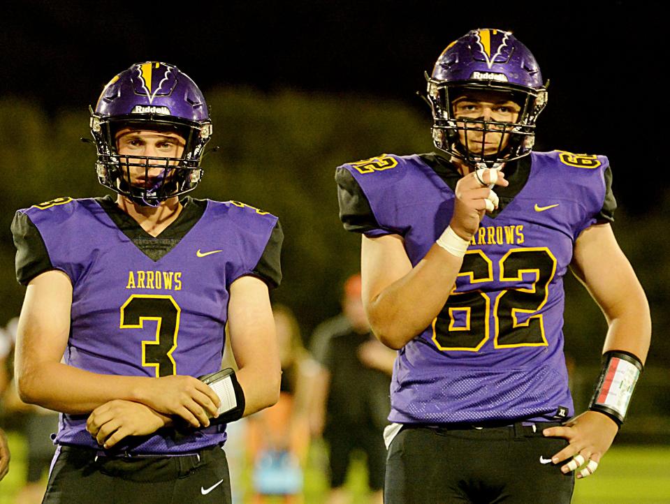 Watertown quarterback Alex Kahre (3) and offensive lineman Chase Crocker wait for the play call from the sideline during the Arrows' 34-19 Eastern South Dakota Conference football win over Huron Friday night at Watertown Stadium.