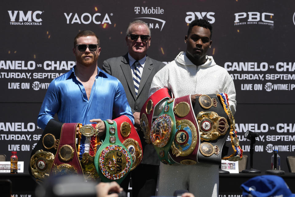 Undisputed super middleweight world champion Canelo Álvarez, left, of Mexico, TGB Promotions boxing promoter Tom Brown, center, and undisputed junior middleweight world champion Jermell Charlo pose for pictures during a boxing news conference in Beverly Hills, Calif., Wednesday, Aug. 16, 2023. (AP Photo/Damian Dovarganes)