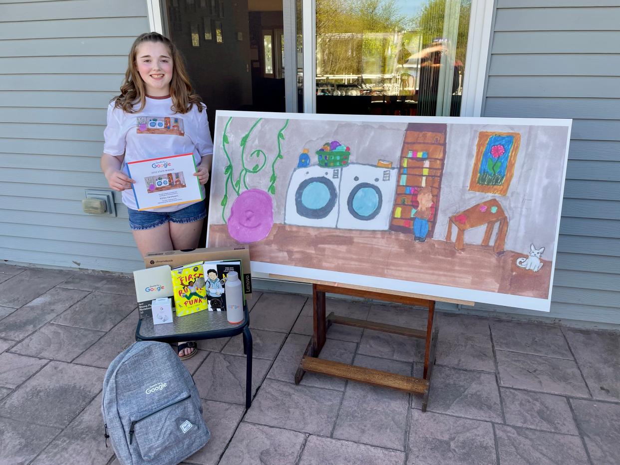 Kinley VanHoorn, a fifth grade student from Milbank, poses with her enlarged Google Doodle entry, "Laundry Break."