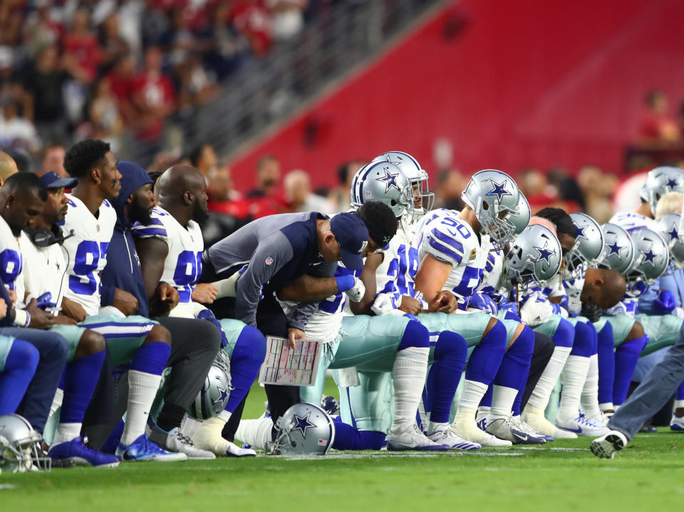 Sept. 25, 2017; Glendale, Ariz., Dallas Cowboys players kneel together with their arms locked prior to the game against the Arizona Cardinals at University of Phoenix Stadium. (Photo: USA Today Sports / Reuters)