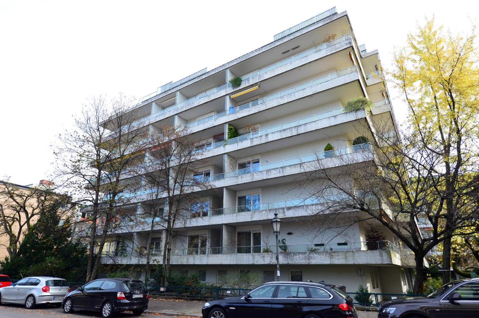 FILE - In this Nov. 4, 2013 file photo cars are parked outside the apartment building in Munich, Germany, where more than 1,400 artworks were found in the apartment of collector Cornelius Gurlitt. Gurlitt, a reclusive German collector whose long-secret hoard of well over 1,000 artworks triggered an international uproar over the fate of art looted by the Nazis, died Tuesday, May 6, 2014. He was 81. (AP Photo/dpa, Marc Mueller, File)