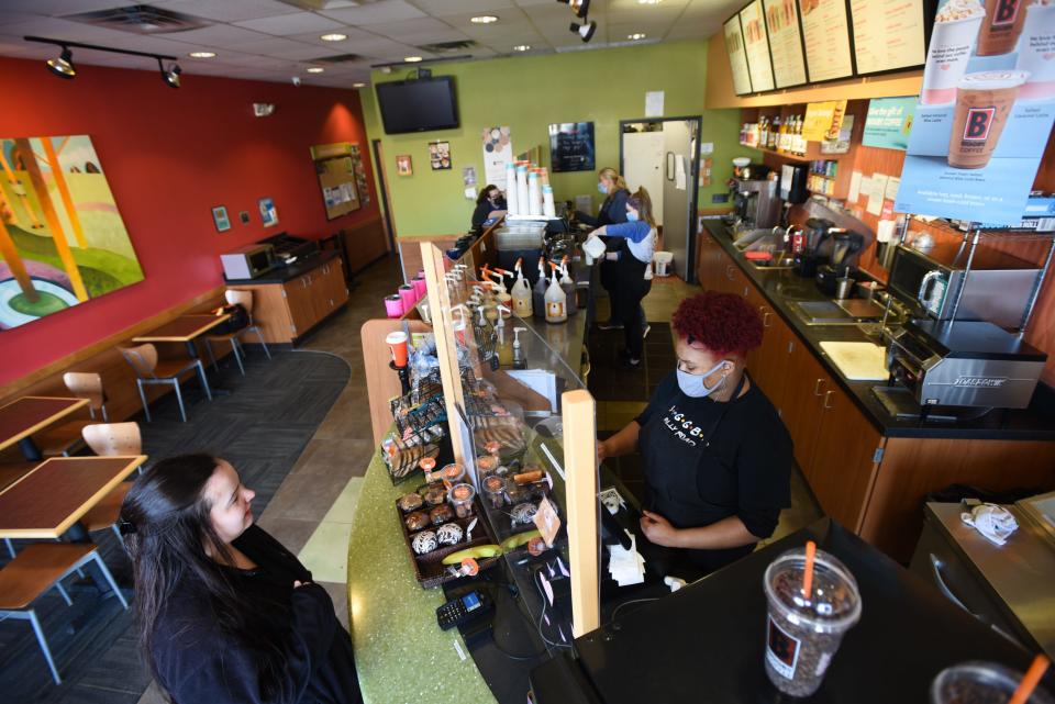 "I work next door, so I come in here at least once a day," Leah Burtt, left, of Lansing says Wednesday, Feb. 9, 2022, after ordering a drink from Kylah Finley at Biggby Coffee on East Jolly Road in Lansing.