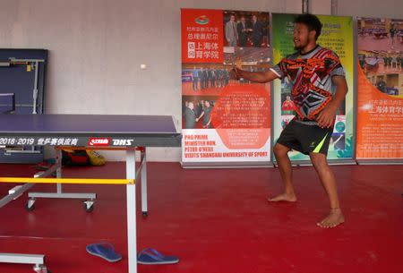 Papua New Guinea table tennis player Gasika Sepa practices in front of promotional posters at a Beijing-funded facility in central Port Moresby in Papua New Guinea, November 19, 2018. REUTERS/David Gray