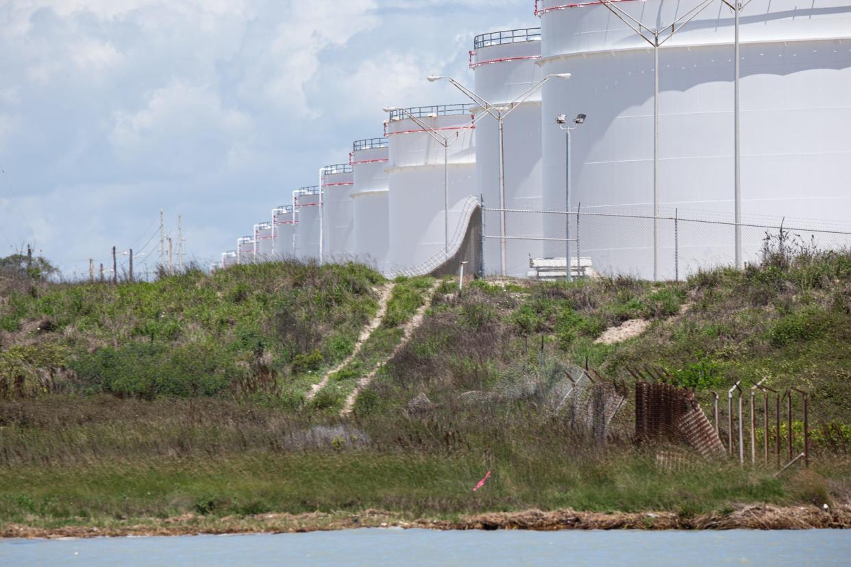 Industrial storage tanks border a strip of land known as McGloin's Bluff, which faces Corpus Christi Bay, on April 15, 2023, in Ingleside Texas. The land is owned by oil exporters Enbridge in Ingleside. Artifacts found in the area suggest the bluff was the site of a Karankawan settlement.