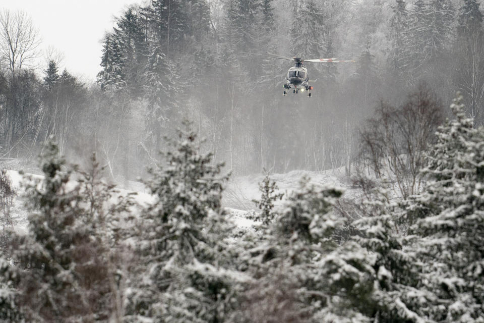 A rescue helicopter files near the site of a landslide in Ask, northeast of Oslo, Thursday, Dec. 31, 2020. A landslide smashed into a residential area near the Norwegian capital Wednesday. (Fredrik Hagen/NTB via AP)