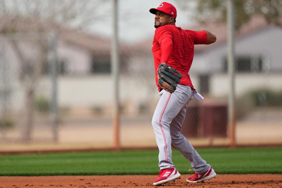 Cincinnati Reds third baseman Jeimer Candelario (3) throws to first base during fielding drills during spring training workouts, Friday, Feb. 23, 2024, at the team’s spring training facility in Goodyear, Ariz.