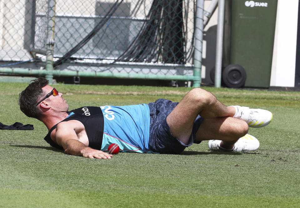 England's James Anderson stretches during their training session at the Gabba ahead of the first Ashes cricket test in Brisbane, Australia, Monday, Dec. 6, 2021. (AP Photo/Tertius Pickard)