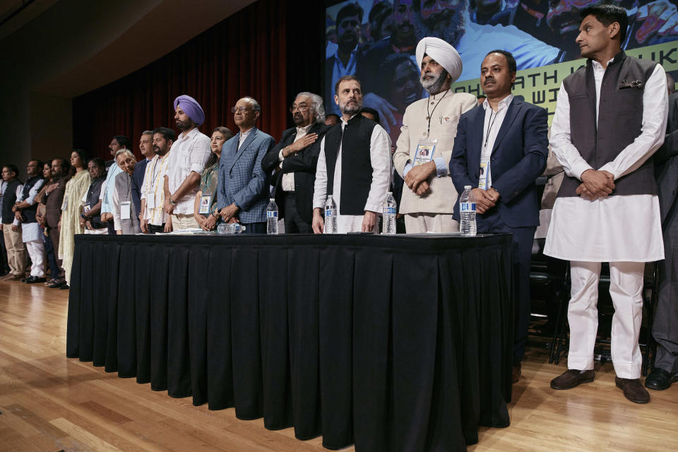 Indian politician Rahul Gandhi, center, listens to the United States national anthem at the Javits Center, Sunday, June 4, 2023, in New York. (AP Photo/Andres Kudacki)