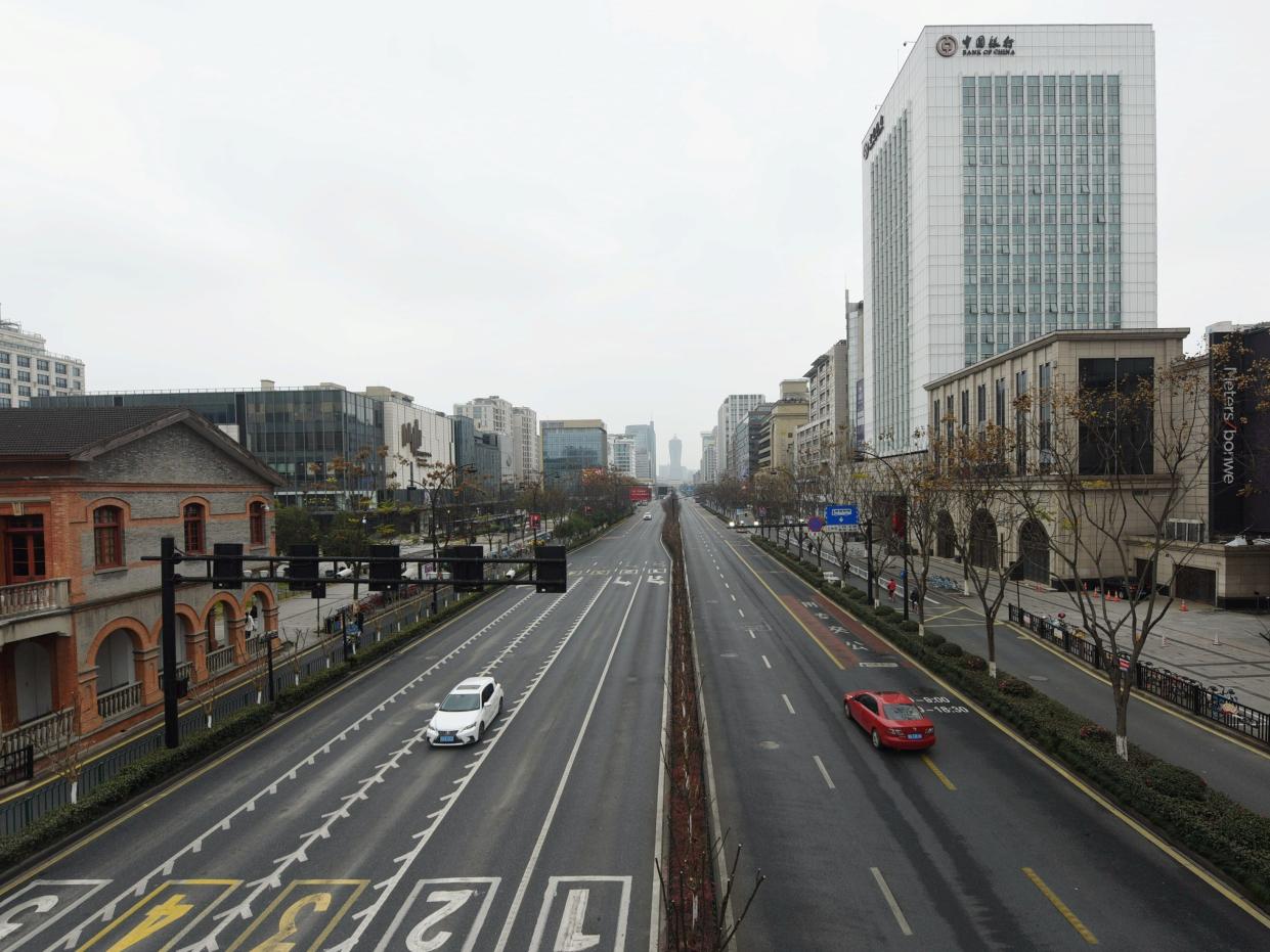 Cars travel on Yanan Road, a main commercial area in Hangzhou, after the city imposed new measures to prevent and control the new coronavirus, in Zhejiang province, China February 4, 2020. China Daily via REUTERS