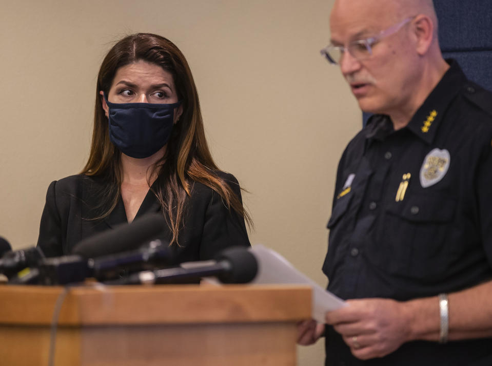 Tucson Mayor Regina Romero, left, listens as Police Chief Chris Magnus speaks during a press conference, Wednesday, June 24, 2020, in Tucson, Ariz. Chief Magnus offered his resignation after the death of a 27-year-old man who died while handcuffed and placed face-down, resulting in the resignation of three officers the chief said had violated department policy. The city council and city manager have to approve resignation. The city council and city manager have to approve resignation. The medical examiner’s office didn’t determine a manner of death but said Carlos Ingram-Lopez had died of sudden cardiac arrest while intoxicated by cocaine and physically restrained. (Josh Galemore/Arizona Daily Star via AP)