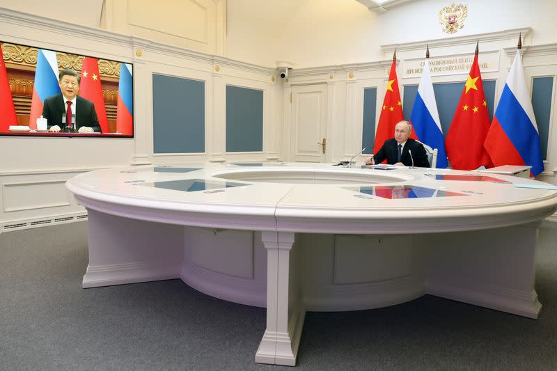 Putin and Xi hold talks via videolink