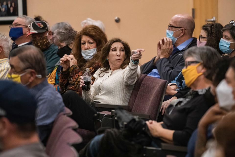 Dora Luchini-Lucero, who spoke out against the gender inclusion policy, points at another meeting attendee after being told to put on her mask at the Las Cruces school board meeting.