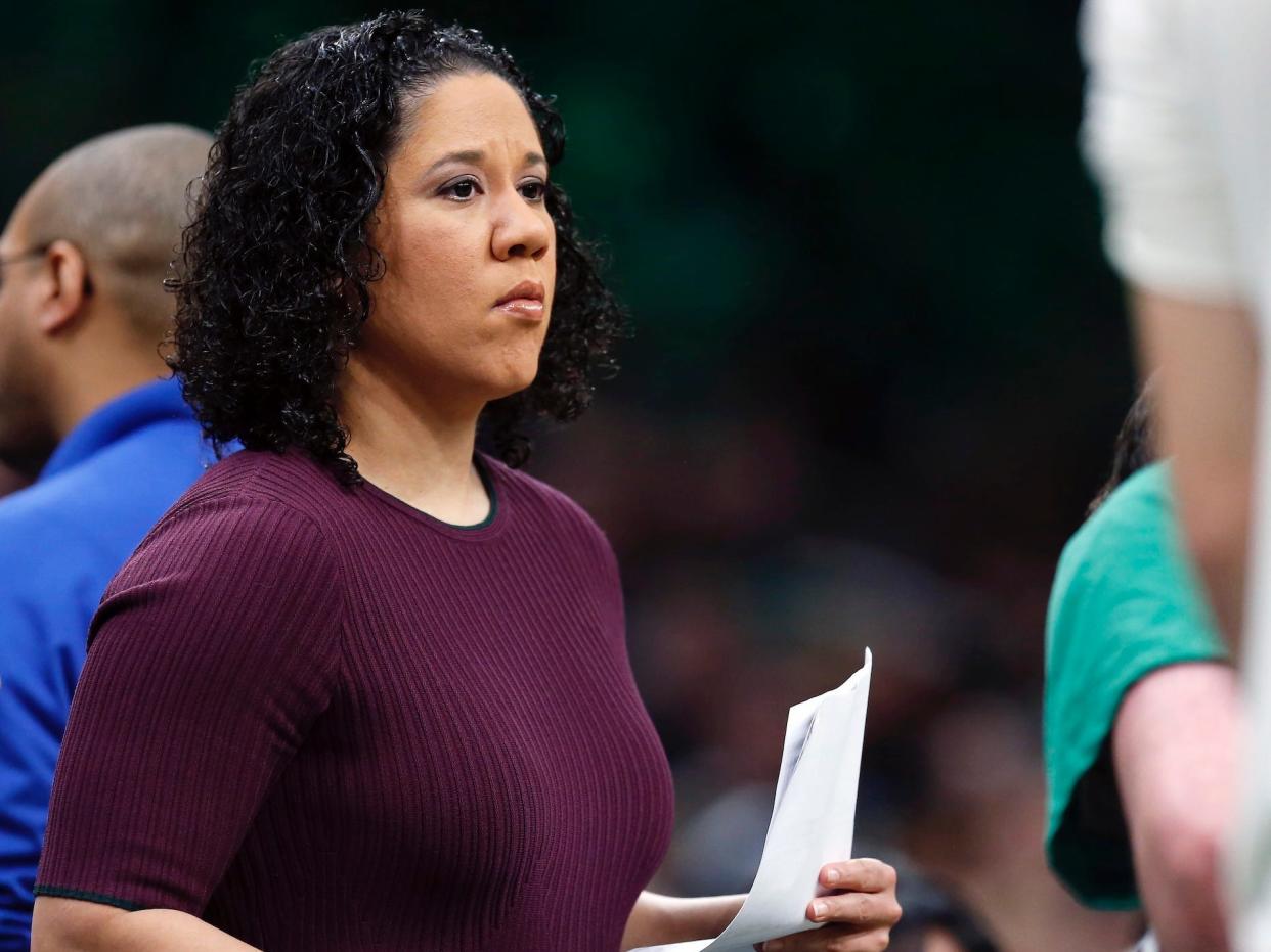 Kara Lawson stands on the sideline.