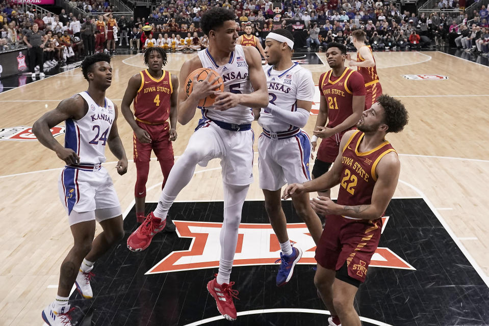 Kansas guard Kevin McCullar Jr. (15) grabs a rebound during the first half of an NCAA college basketball game against Iowa State in the semifinal round of the Big 12 Conference tournament Friday, March 10, 2023, in Kansas City, Mo. (AP Photo/Charlie Riedel)