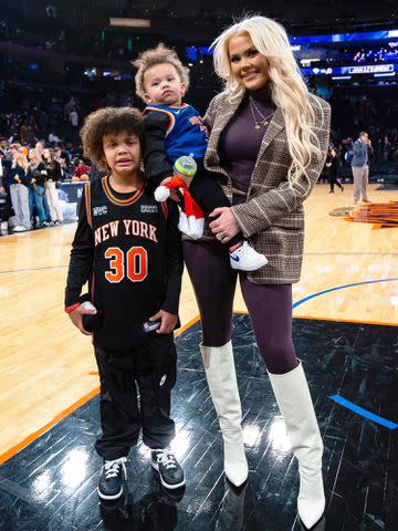 Facebook Kendra Randle on the court with her two kids.