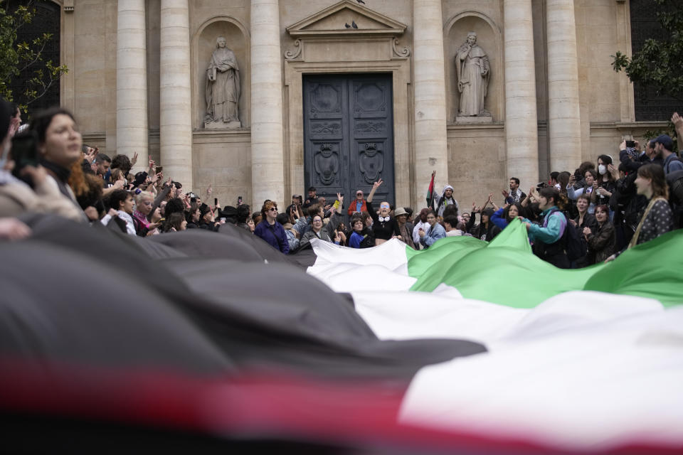 Students demonstrate outside La Sorbonne university with a huge Palestinian flag, Monday, April 29, 2024 in Paris. About 100 Pro-Palestinian students demonstrate near the Sorbonne university in Paris. The demonstration came on the heels of protests last week at another Paris-region school, Sciences Po. (AP Photo/Christophe Ena)