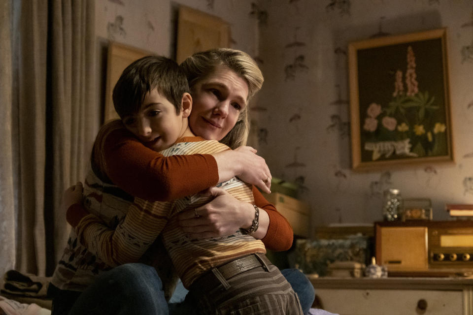 Lili Rabe hugs a young boy