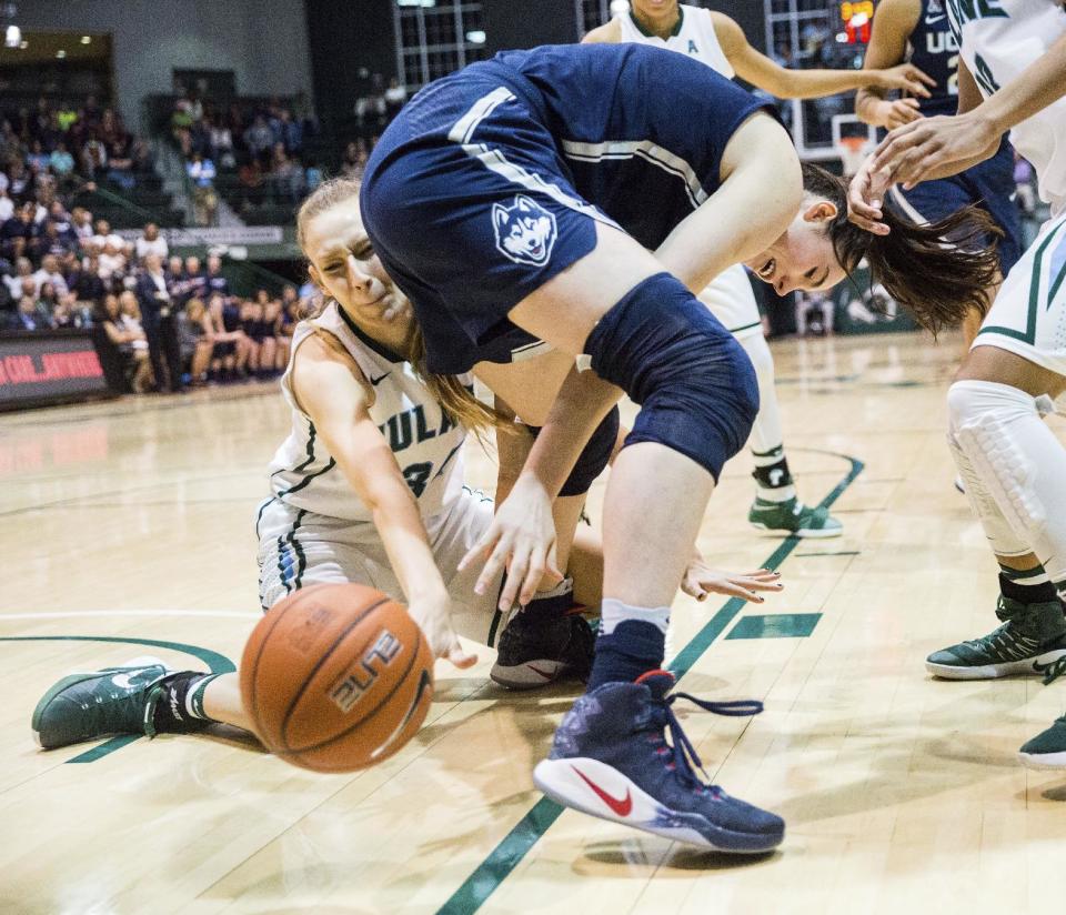 Tulane center Ksenija Madzarevic (34) tries to get the ball after Conneticut's Natalie Butler (51) losy control of it during the first half of an NCAA college basketball game in New Orleans, Saturday, Feb. 18, 2017. (AP Photo/Sophia Germer)