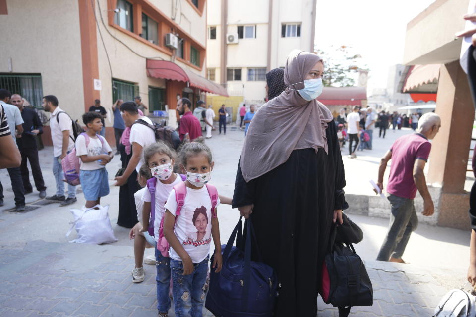 Palestinian children with chronic diseases stand next to their mother as they wait to leave the Gaza Strip for treatment abroad through the Kerem Shalom crossing, in Khan Younis, southern Gaza Strip, Thursday, June 27, 2024. 21 patients in the Gaza Strip evacuated the war-torn enclave in an initiative led by the World Health Organization for the children to receive life-saving treatment elsewhere. (AP Photo/Abdel Kareem Hana)