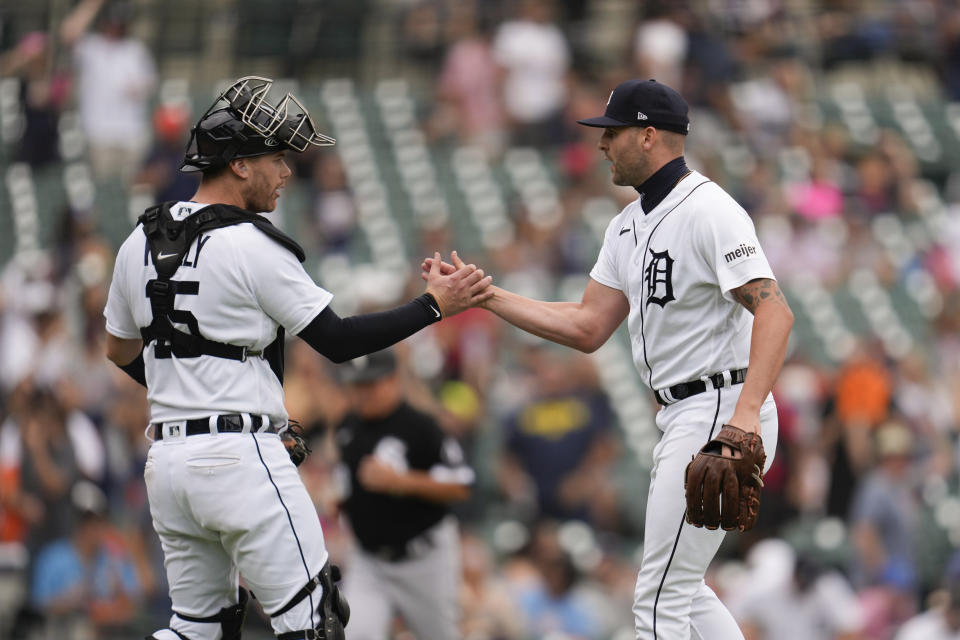 Detroit Tigers catcher Carson Kelly (15) and Detroit Tigers relief pitcher Alex Lange (55) celebrate after the final out against the Chicago White Sox in the ninth inning of a baseball game, Sunday, Sept. 10, 2023, in Detroit. (AP Photo/Paul Sancya)