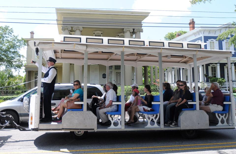 John Pucci leads a Springbrook Farms horse drawn carriage and trolley tour on Front St. in downtown Wilmington Saturday, August 24, 2013. Guided tours are a great way to see the city and learn tales and local folklore.