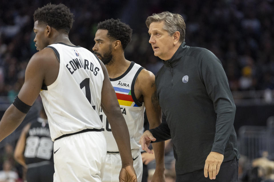 FILE - Minnesota Timberwolves head coach Chris Finch, right, speaks with guards Mike Conley, center, and Anthony Edwards, left, during the first half of an NBA basketball game against the San Antonio Spurs, Saturday, April 8, 2023, in Austin, Texas. The Timberwolves have two All-Stars in their lineup and the best defense in the NBA, but they likely wouldn't have secured the second-most wins in franchise history without a behind-the-scenes boost from a coaching staff led by Chris Finch that has forged a strong sense of camaraderie with each other and a clear level of trust with the players. (AP Photo/Stephen Spillman, File)