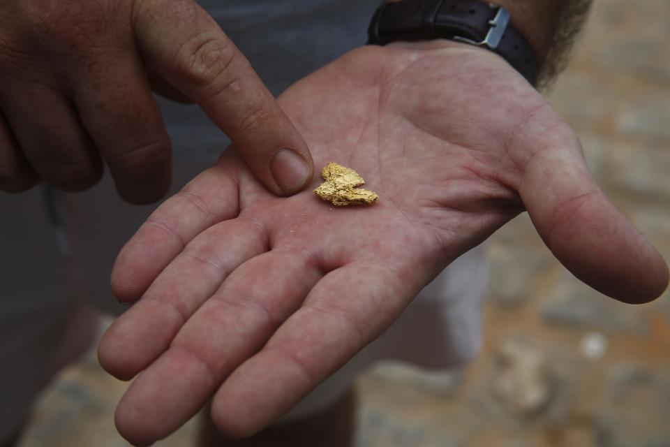 FILE - An airplane pilot who works in an illegal mine shows gold extracted from territory of the Indigenous Yanomami tribe in Alto Alegre, Roraima state, Brazil, Feb. 7, 2023. Yanomami leaders have urged people not to buy gold jewelry at all, regardless of its source, because demand for the precious metal drives gold prices up and pushes miners into their territory. (AP Photo/Edmar Barros, File)