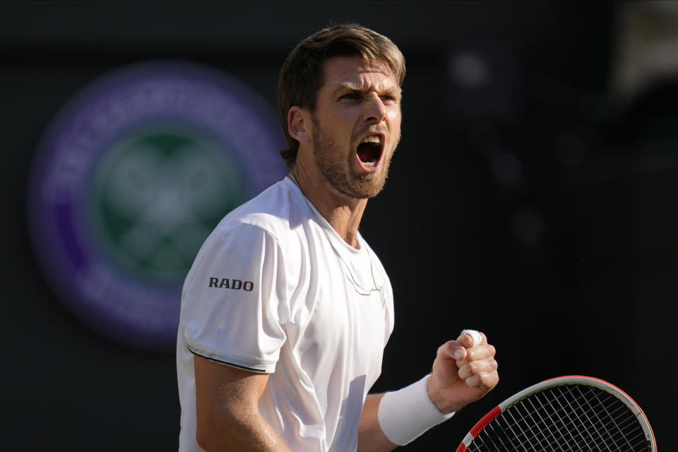 Britain's Cameron Norrie celebrates winning the men's singles quarterfinal match against Belgium's David Goffin at the Wimbledon tennis championships in London, Tuesday July 5, 2022. (AP Photo/Kirsty Wigglesworth)