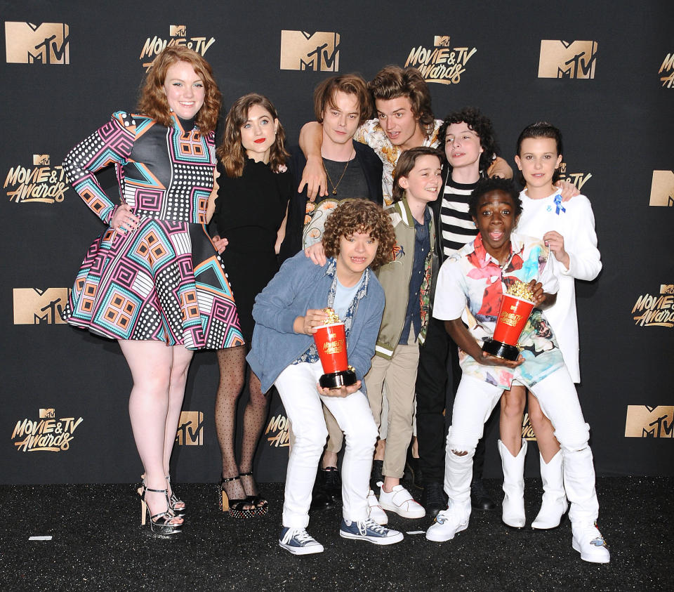 (L-R) Actors Shannon Purser, Natalia Dyer, Charlie Heaton, Gaten Matarazzo, Caleb McLaughlin, Noah Schnapp, Finn Wolfhard, Joe Keery and Millie Bobby Brown of 'Stranger Things' pose in the press room at the 2017 MTV Movie and TV Awards at The Shrine Auditorium on May 7, 2017 in Los Angeles, California.