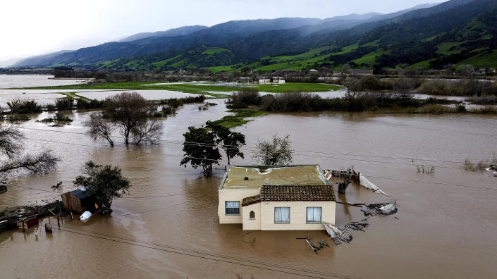 Floodwaters surround a home in the Chualar community of Monterey County, Calif., as the Salinas River overflows its banks on Friday, Jan. 13, 2023. (AP Photo/Noah Berger)