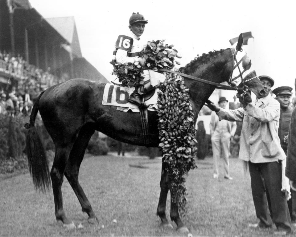 FILE - Broker's Tip, with jockey Don Meade up, is shown covered with roses in the winner's circle after winning the Kentucky Derby at Churchill Downs in Louisville, Ky., May 6, 1922. (AP Photo)