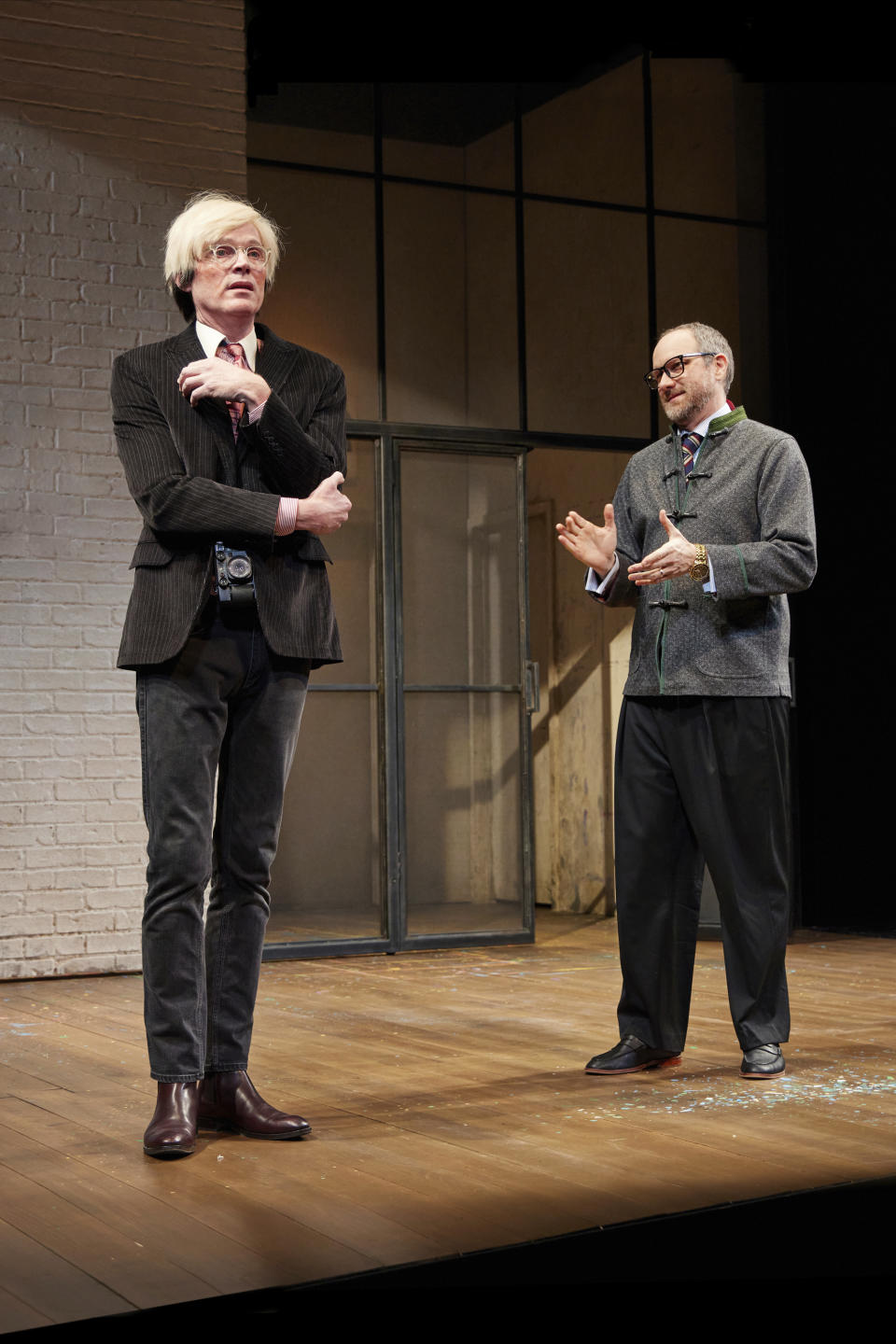 This image provided by Jeremy Daniel shows Paul Bettany as Andy Warhol, left, and Erik Jensen as Bruno Bischofberger, in a scene from "The Collaboration," Anthony McCarten's fictional account about the real period in 1984 when Warhol was compelled to work with new sensation and potential rival of the New York art world, Jean-Michel Basquiat. (Jeremy Daniel via AP)