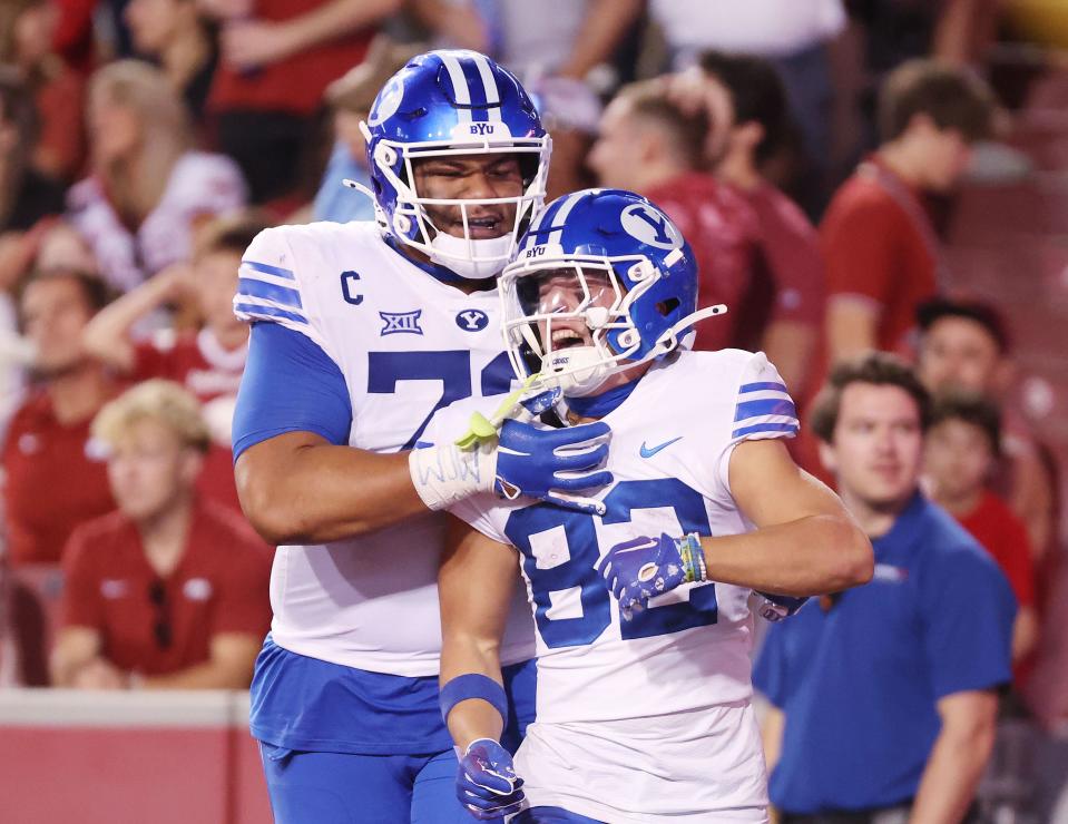 Brigham Young Cougars wide receiver Parker Kingston (82) celebrates his touchdown with offensive lineman Kingsley Suamataia (78) at Razorback Stadium in Fayetteville on Saturday, Sept. 16, 2023. BYU won 38-31. | Jeffrey D. Allred, Deseret News