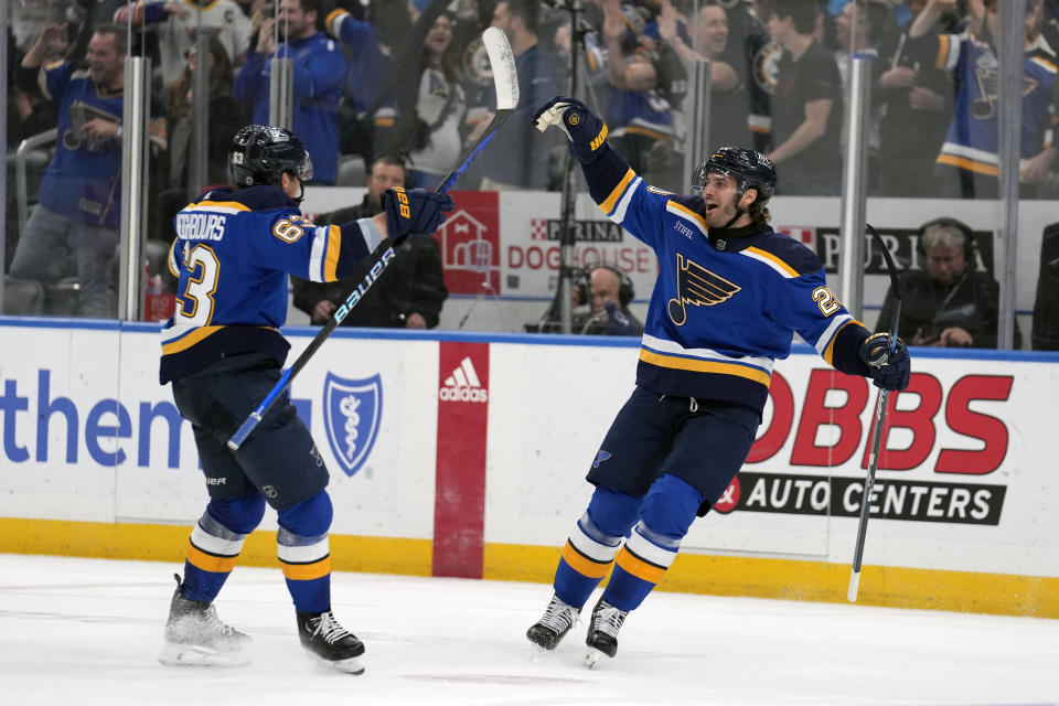 St. Louis Blues' Brandon Saad, right, is congratulated by Jake Neighbours (63) after scoring the game-winning goal during overtime of an NHL hockey game against the Edmonton Oilers Monday, April 1, 2024, in St. Louis. (AP Photo/Jeff Roberson)