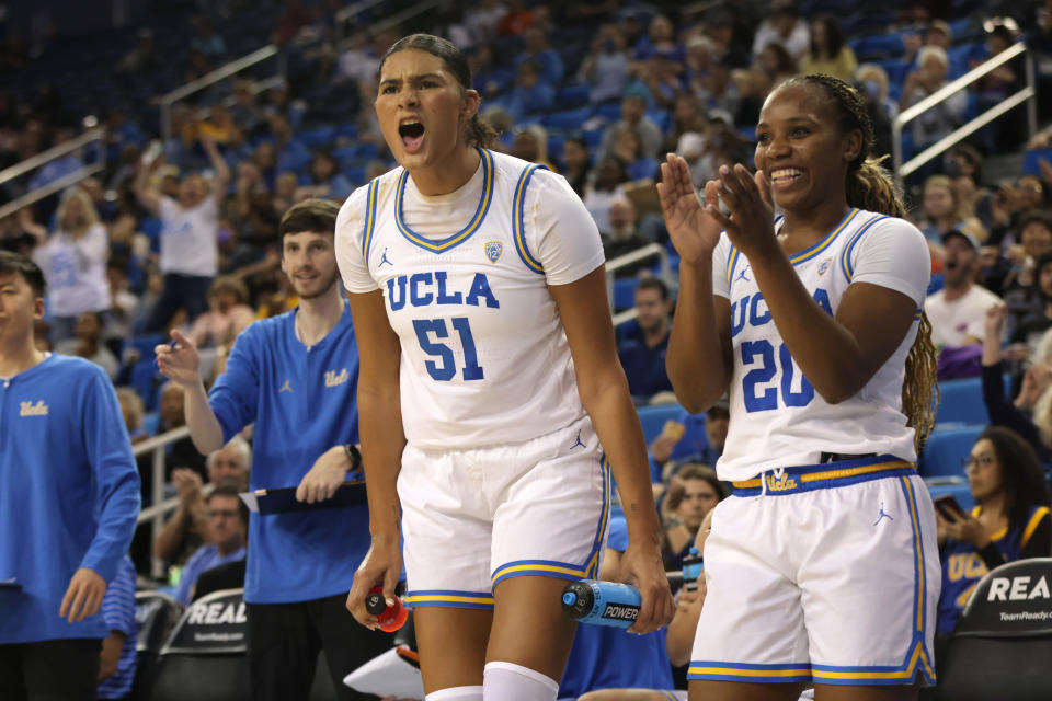UCLA's Lauren Betts (L) and Charisma Osborne cheer from the bench during the second half of their season-opening game against Purdue at Pauley Pavilion in Los Angeles, on Nov. 6, 2023. (Photo by Katharine Lotze/Getty Images)